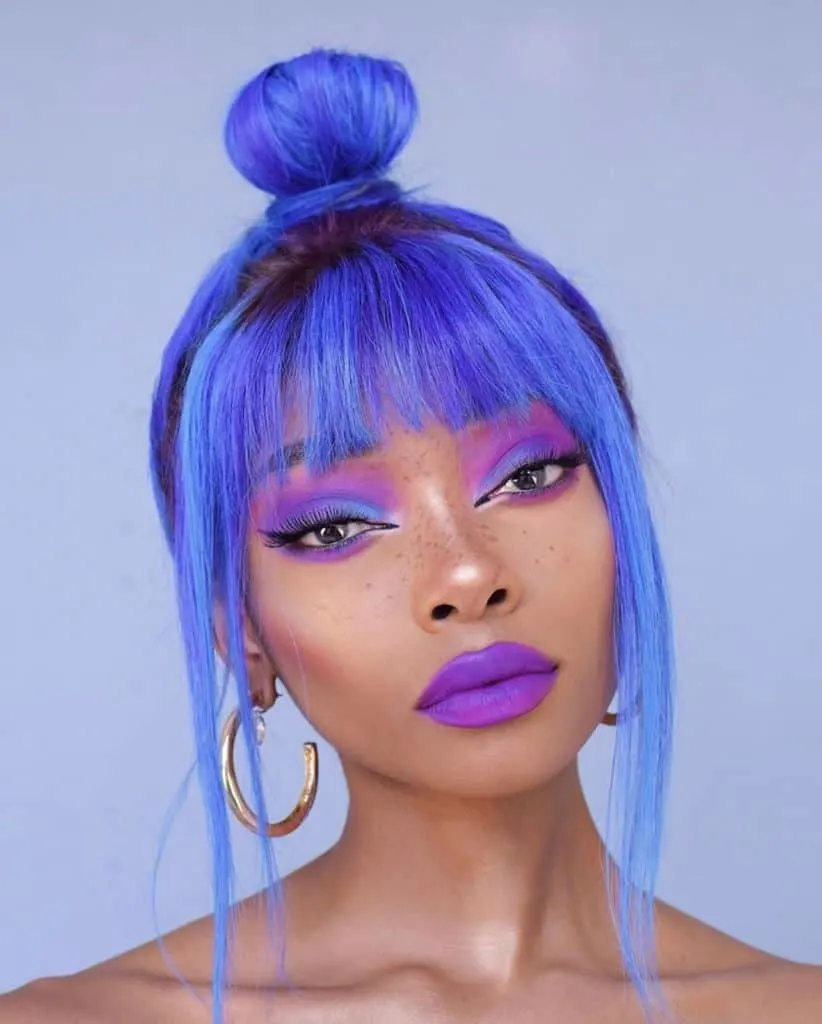 nyane blue hair with a fringe in a bun