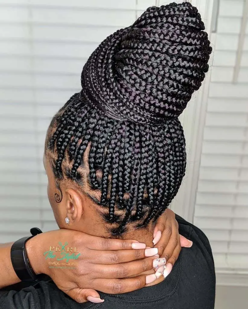 medium knotless box braids in a bun