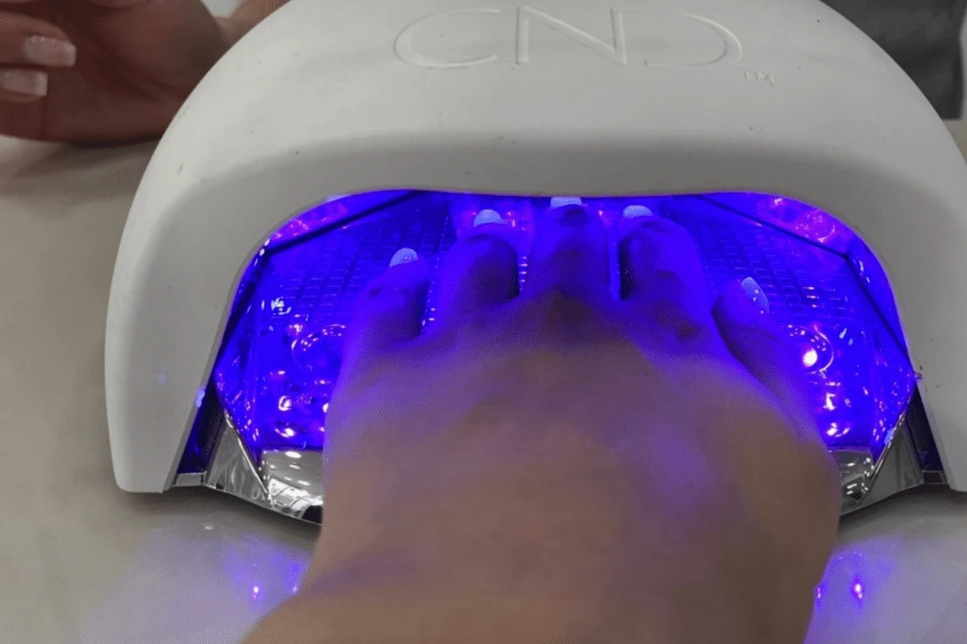 A photograph of my gel nails being dried in the CND Nail Lamp