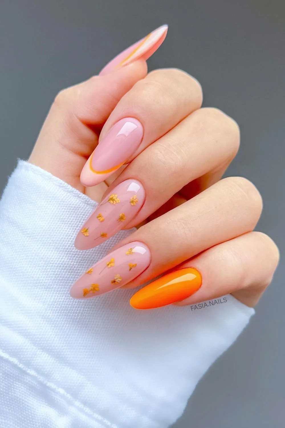 Orange nail designs evoke the lively spirit of summer, reminiscent of sunny days and refreshing treats. From sunset-inspired ombré to creamy, citrusy hues, there are endless creative ways to incorporate shades of orange into your manicure.  Whether you prefer bold and punchy tones, or softer pastel oranges, these 21 nail designs are guaranteed to add a playful and vibrant touch to your look! summer, spring, fall, winter, natural nails, acrylic, gel nails, dip nails, nail art, oval, squoval, square, almond, round, pink and, short, burnt, blue and, light, red, black and, yellow and, short, coffin.