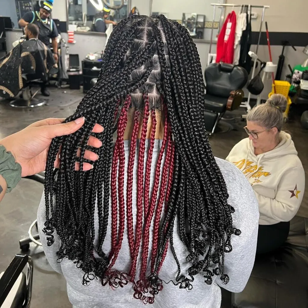 Burgundy peekaboo knotless braids with curly ends